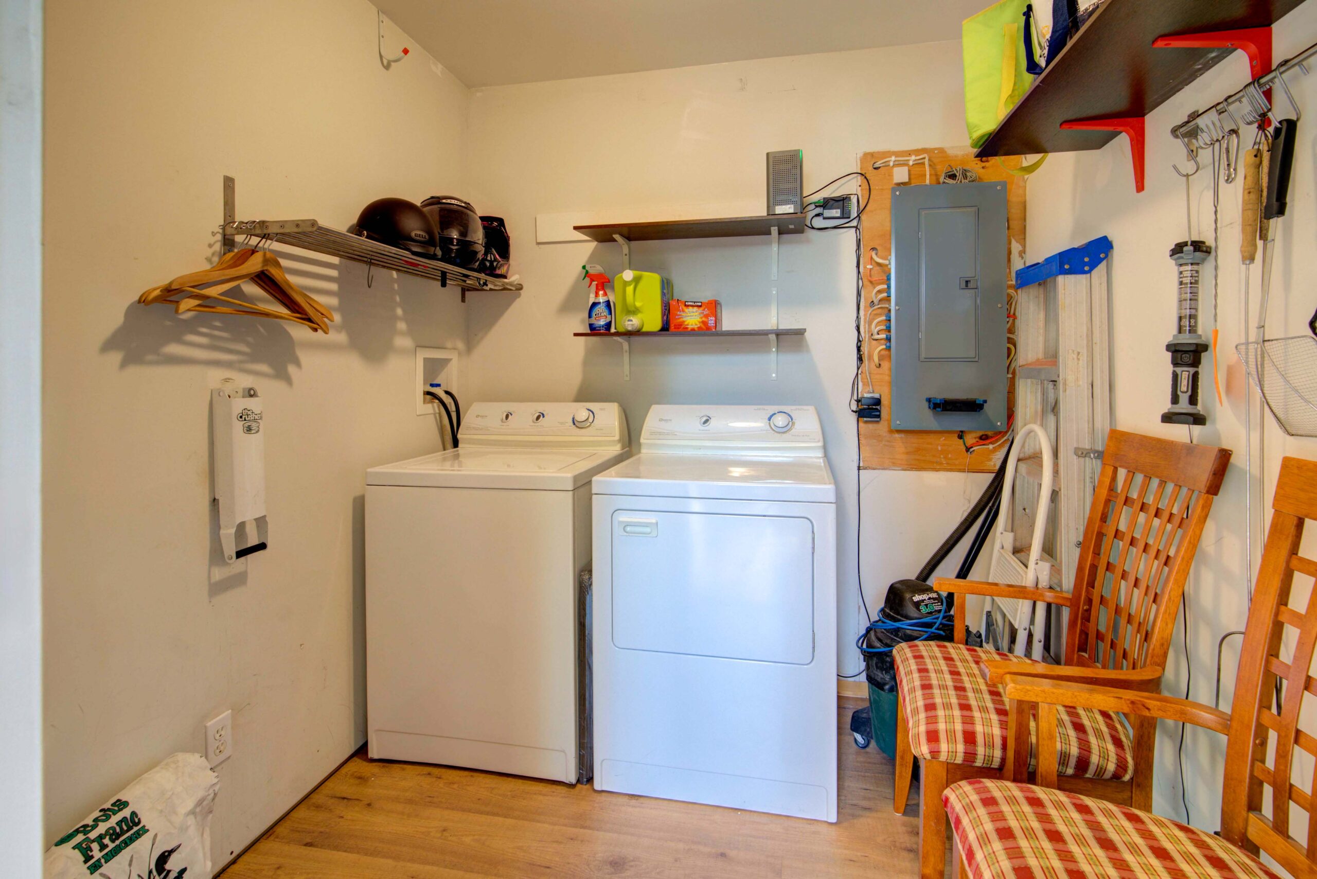 White laundry machines in a small white room