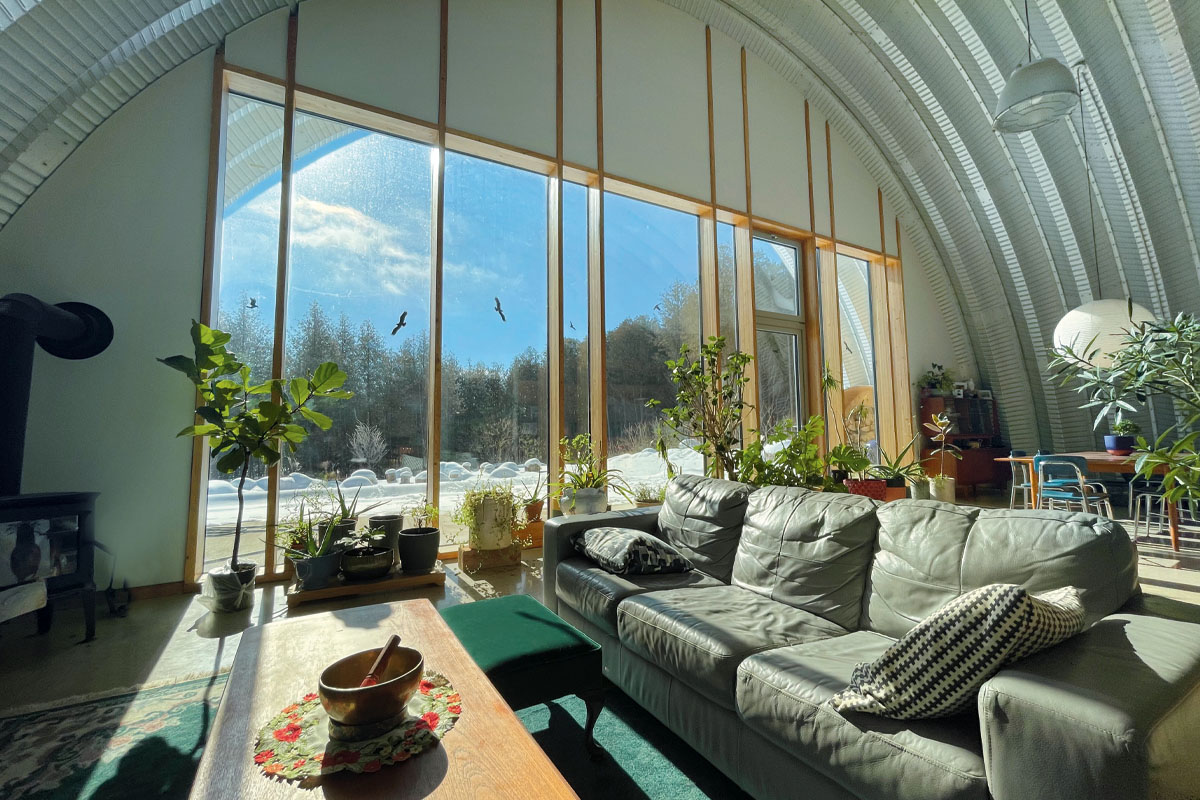 floor-to-ceiling windows in a living room, sunlight streaming in
