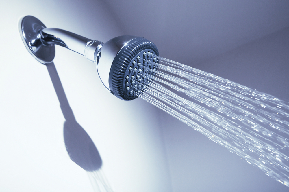 A shower head with water coming out of it