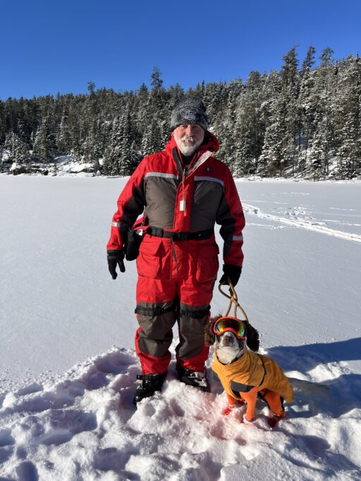 Poppy pictured here with her trainer/owner, Paul Bunker, during a research outing on a frozen lake.