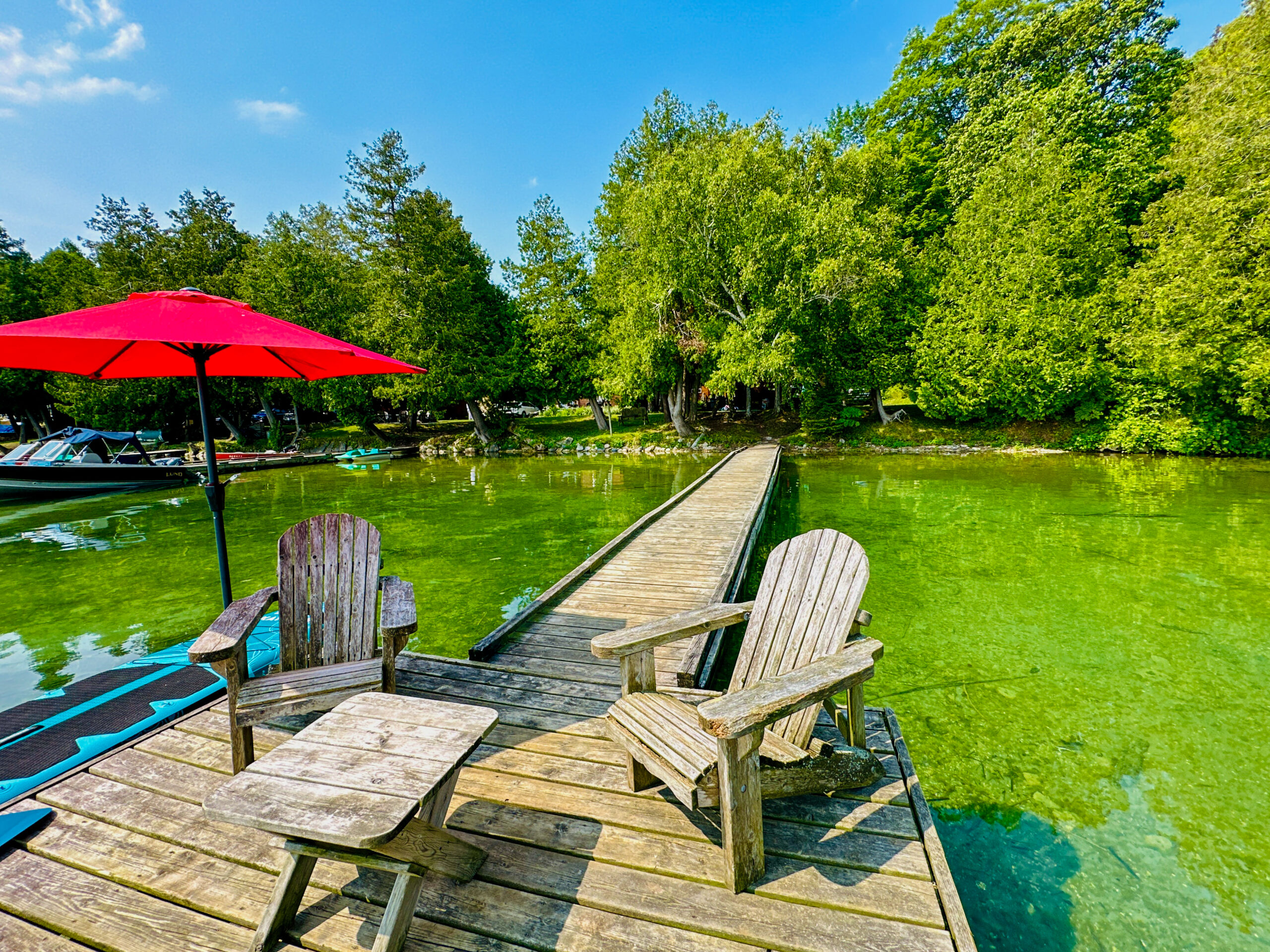 A well-maintained dock extending into Lake Mindemoya, offering access for boats and water activities.