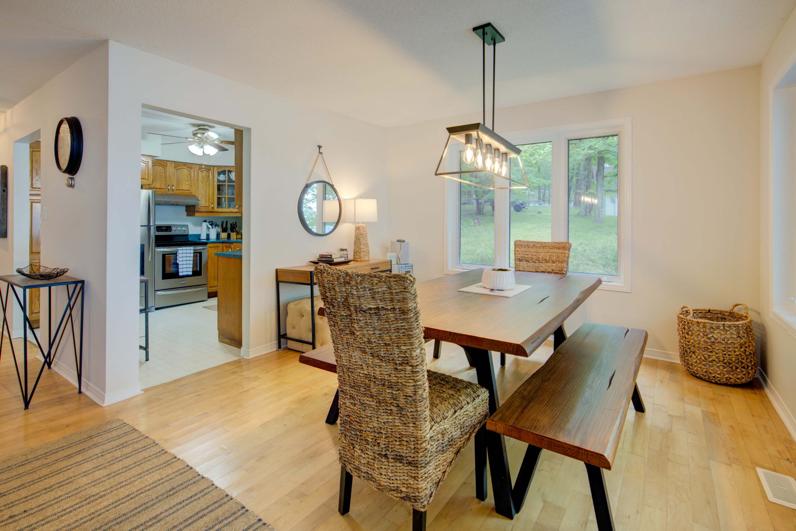 A wood dining table in a wood-paneled room
