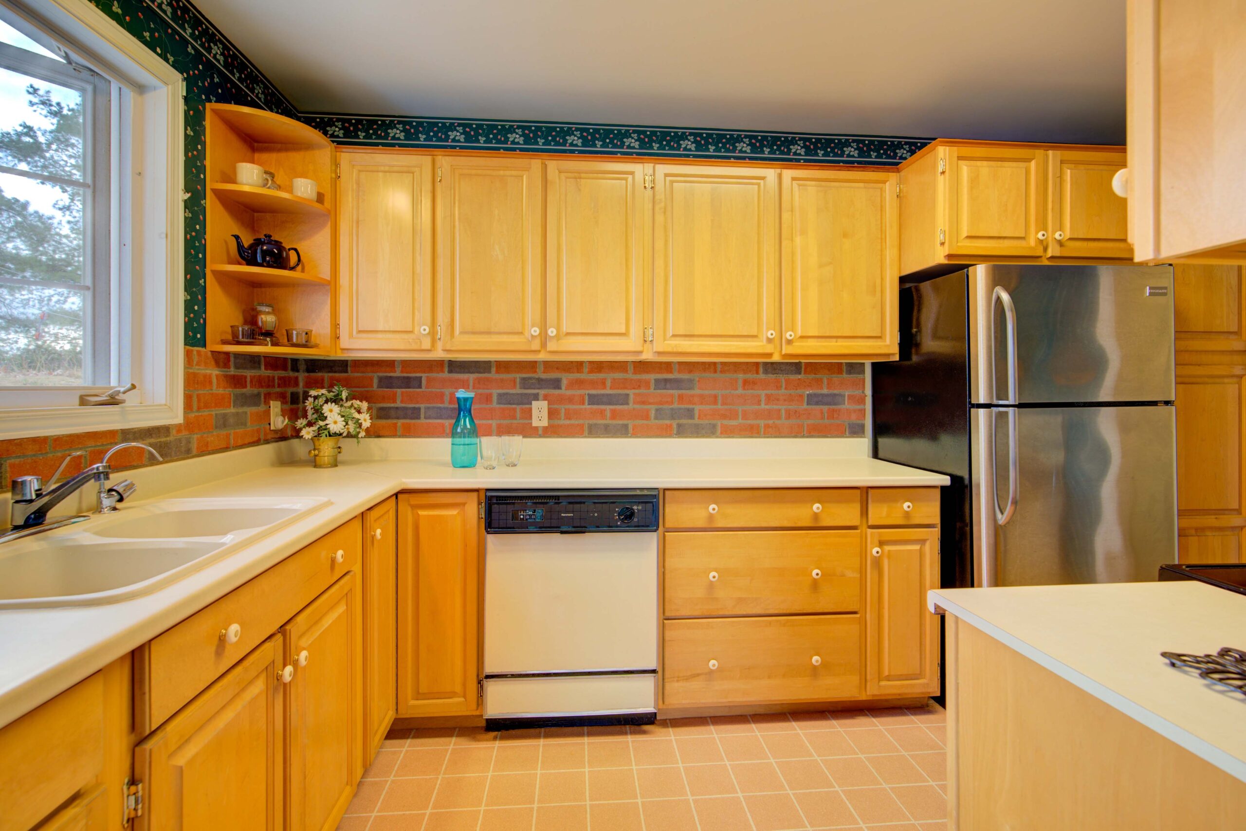 A wood kitchen with a white dishwasher