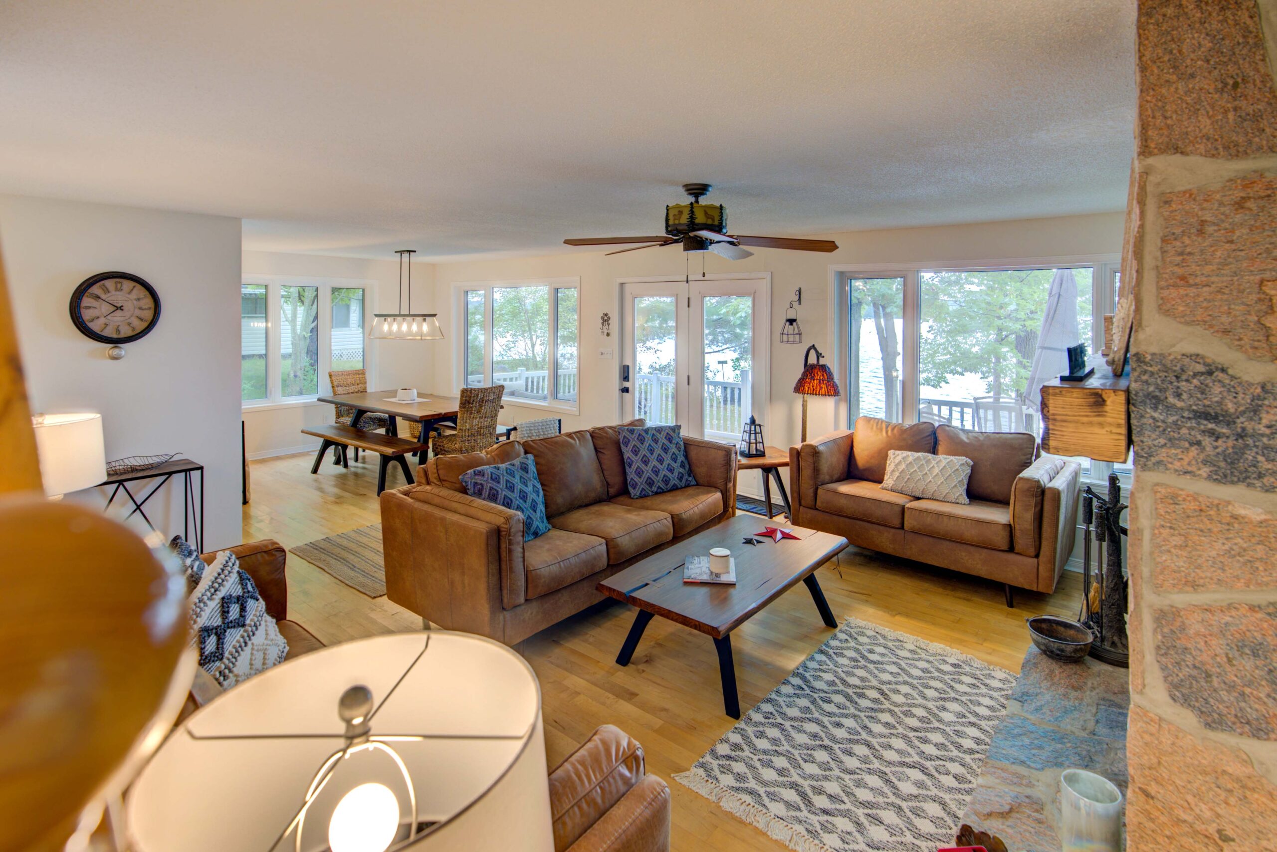 Brown suede couches in a bright living room face a coffee table