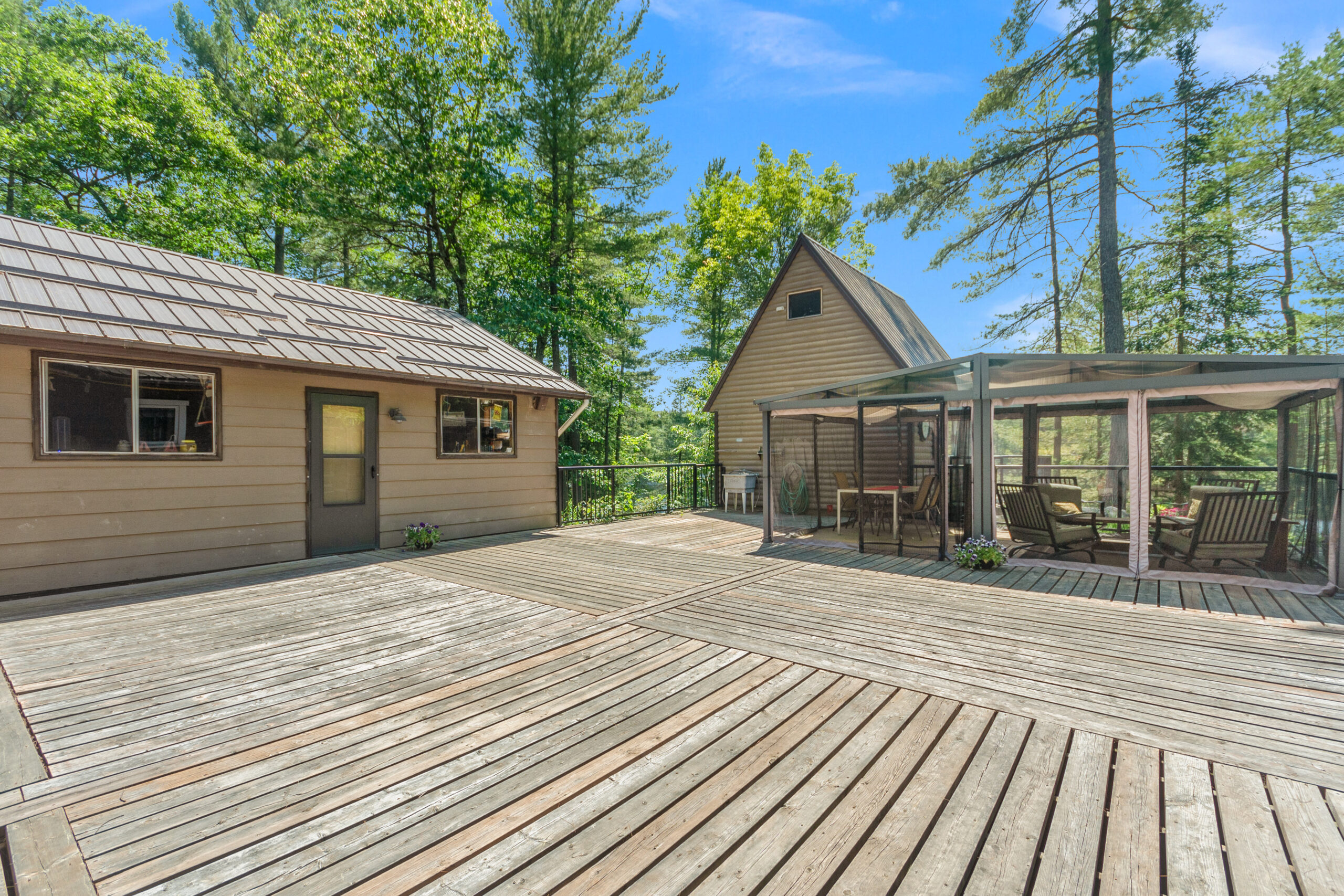 A spacious wood deck with wood-paneled dwellings