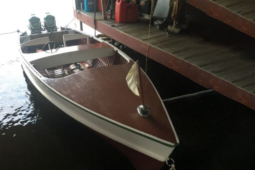 16 foot cedarstrip boat inside a boathouse