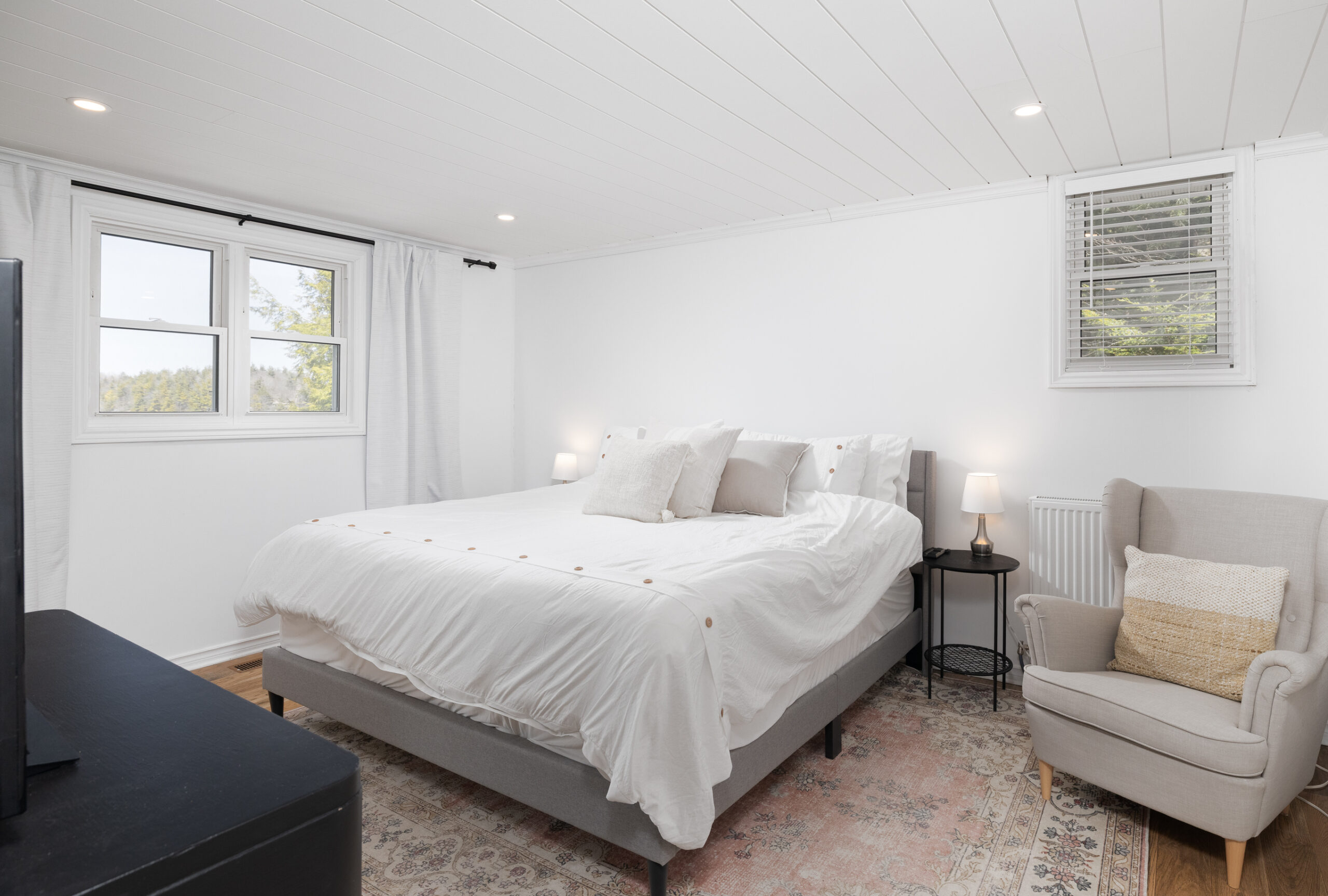 A large white bed in a white bedroom