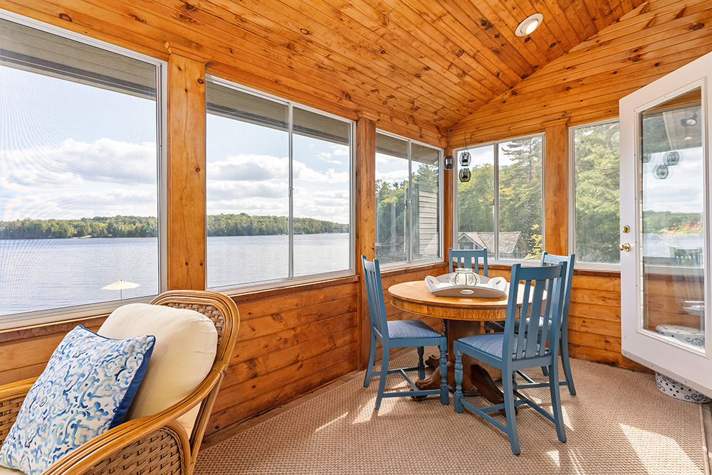 Three-season Muskoka room with panoramic windows and views of Lake of Bays