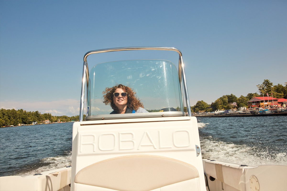 Bryn Turnbull drives a boat on Georgian Bay