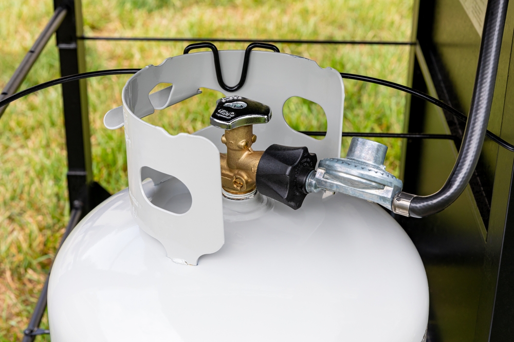 A propane tank attached to a gas grill