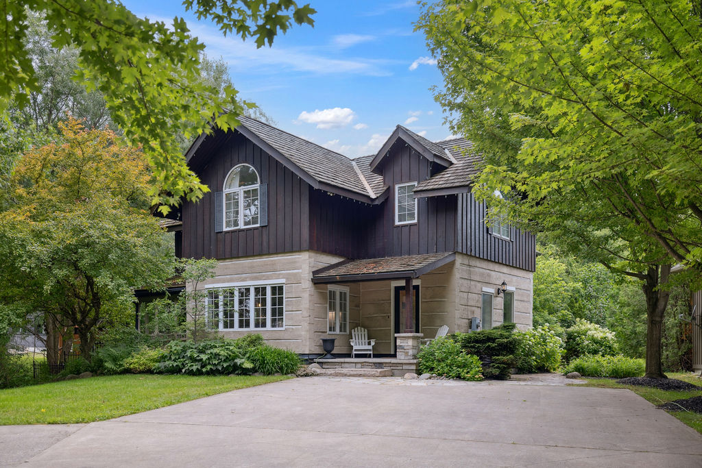 A grey stone and dark paneled cottage