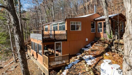 An orange-toned cottage with a double deck