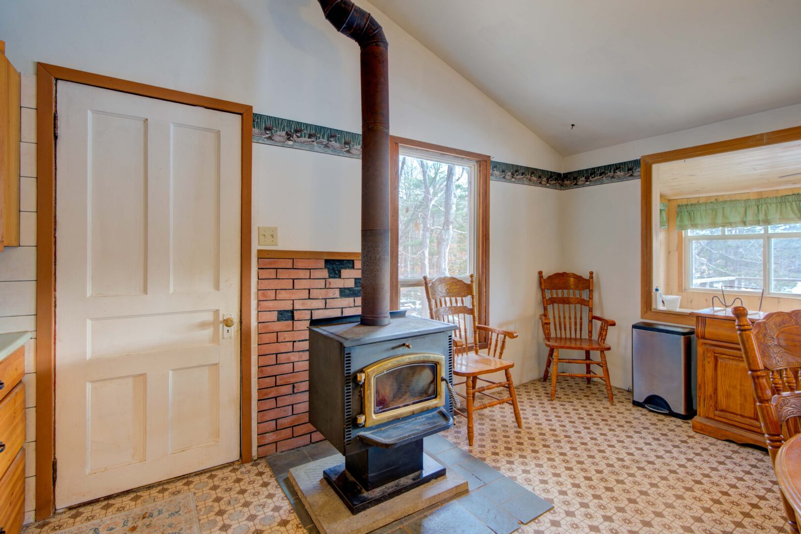 A black wood stove in a white cabin