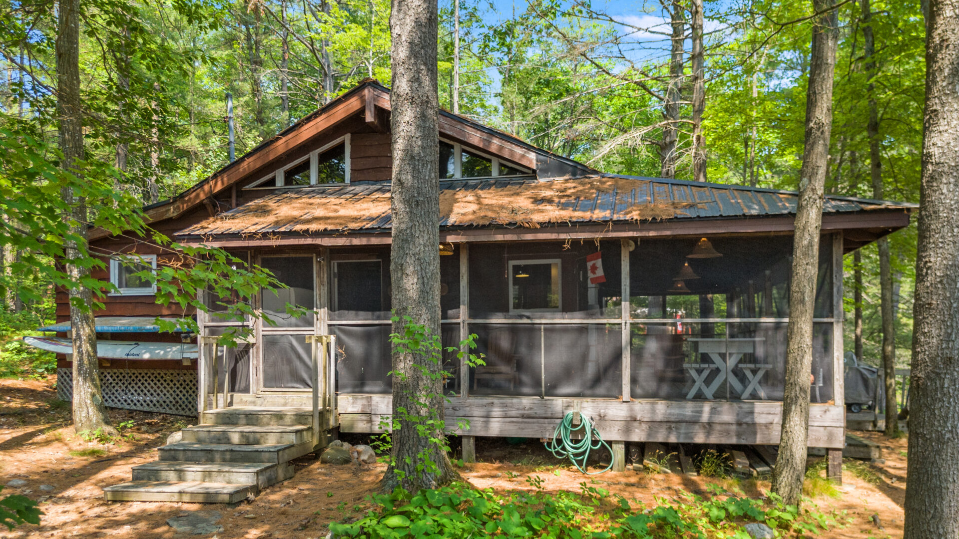 A wood cottage with a screened-in porch