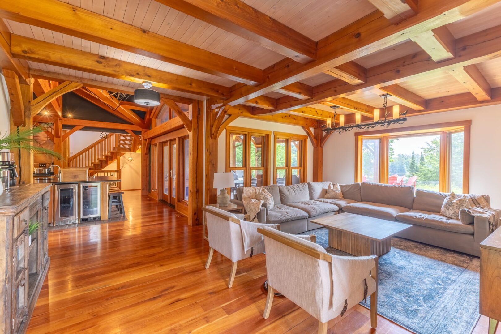 A small dining table with white chairs in a wood room