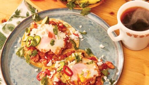 Huevos Rancheros with Sausage and Grilled Avocado on a table