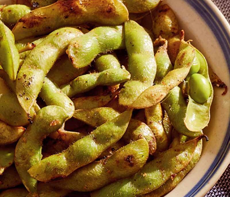 Grilled ginger-garlic edamame in a bowl