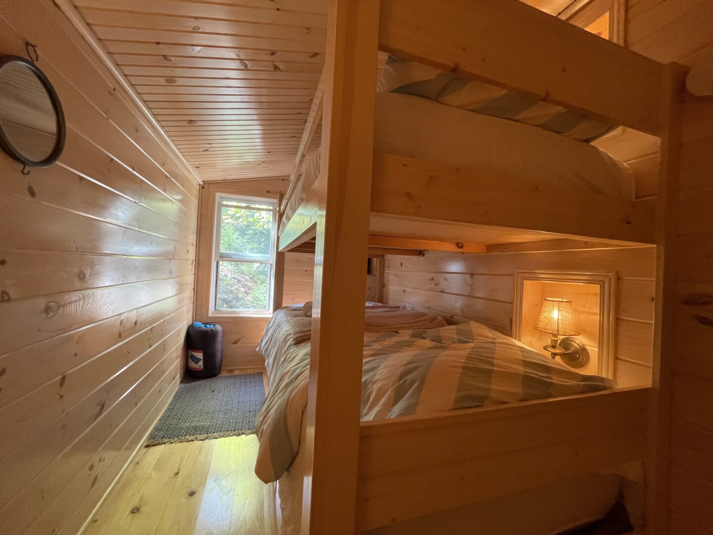 Wood bunk beds in a wood paneled room