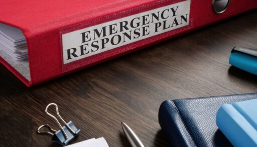 A binder and supplies that says Emergency Response Plan